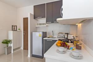 a kitchen with a bowl of fruit on a counter at CHIC CONDO - Amazing mountain view near Karon beach B513 in Karon Beach