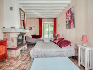 a living room with two beds and a fireplace at Farmhouse in Boncourt with Private Garden in Sainte-Preuve