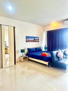 a bedroom with a blue bed and a blue couch at CHIC CONDO - Amazing mountain view near Karon beach B513 in Karon Beach +21 photos