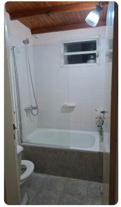 a bathroom with a bath tub and a toilet at Patagonia's Faro Norte Lighthouse in Patagones