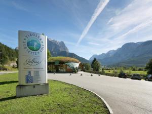 a sign on the side of a road with a building at Apartment in Hinterbichl near Ski Bus in Reutte