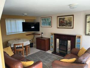 a living room with a couch and a fireplace at Rain Hill Cottage - Sleeps 4 Parking & Pets Ok in Louth