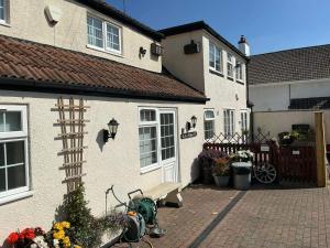 a green scooter parked in front of a house at Rain Hill Cottage - Sleeps 4 Parking & Pets Ok in Louth