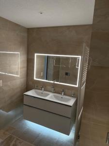 a bathroom with a sink and a mirror at Schweizerhaus Glarus - Historisch & Stilvoll mit Garten in Ennenda