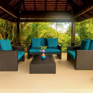 a patio with blue chairs and a vase on a table at Blue Samui Ocean Villa - 3 Large Ensuite Bedrooms - Private Pool, Jacuzzi Villa & Car with driver - Near Four Seasons - Ocean & Mountains Views in Nathon Bay