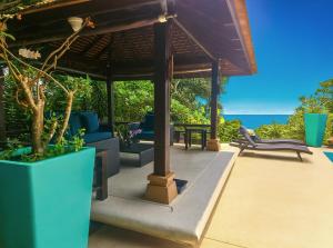 a patio with a gazebo and chairs and the ocean at Blue Samui Ocean Villa - 3 Large Ensuite Bedrooms - Private Pool, Jacuzzi Villa & Car with driver - Near Four Seasons - Ocean & Mountains Views in Nathon Bay