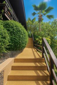 a staircase leading to a building with a palm tree at Blue Samui Ocean Villa - 3 Large Ensuite Bedrooms - Private Pool, Jacuzzi Villa & Car with driver - Near Four Seasons - Ocean & Mountains Views in Nathon Bay