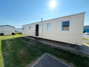 a mobile home with the door open in a yard at Superb 8 Berth Caravan At St Osyth Beach Holiday Park, Essex Ref 28010Mv in Clacton-on-Sea
