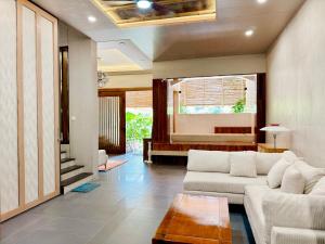 a living room with a couch and a table at Lakeview Park Residence - 2 Separate Duplexes, Each with a Private Pool - Read !About the Property! Before Booking in Ho Chi Minh City