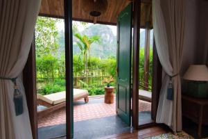 a room with a door open to a patio at Aman Retreat Ninh Binh in Ninh Binh +66 photos
