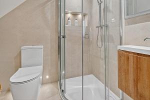 a bathroom with a shower and a toilet and a sink at 46 Tannery Mews in York +21 photos