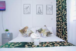 a bedroom with a bed with pillows and a blanket at The Marve in Mombasa