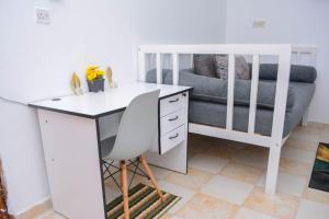 a desk and a chair in a room with a couch at The Marve in Mombasa