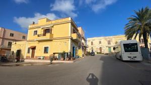 a white truck parked in front of a yellow building at A casa mia - Appartamento vacanze in Lampedusa