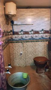 a bathroom with a toilet and a sink at RHS rooms in Tiruvannāmalai