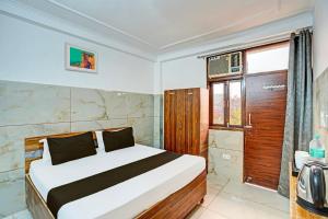 a bedroom with a large bed and a window at HOtel O The Clarks Inn in Indirapuram +21 photos