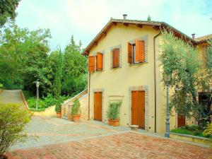 a house with orange doors and a brick driveway at Apartment in Perugia with Pool & Terrace in Perugia +13 photos
