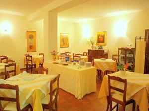a dining room with tables and chairs with white table cloth at Apartment in Perugia with Pool & Terrace in Perugia