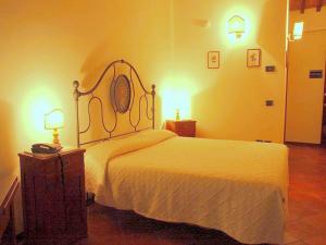 a bedroom with a bed and two lights on the wall at Apartment in Perugia with Pool & Terrace in Perugia