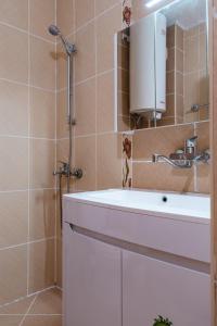 a bathroom with a white sink and a mirror at Renovated 1 Bedroom - Full Kitchen - Parking - 4km Tsarevets in Veliko Tŭrnovo