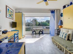 a living room with a couch and a table at Vacances au port in Saint Cyprien Plage