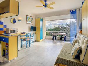 a kitchen and living room with a couch and a table at Vacances au port in Saint Cyprien Plage