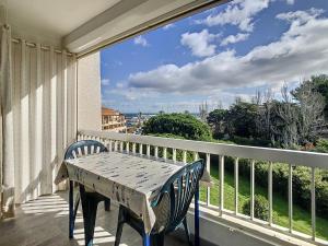 a table and chairs on a balcony with a view at Vacances au port in Saint Cyprien Plage +5 photos