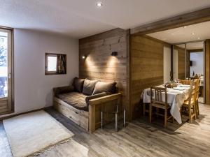 a living room with a couch and a dining room with a table at Charme et Confort au Centre de Val d'Isère – 2 Pièces Cabine Rénové pour 5 Pers., Proche Pistes - FR-1-518-25 in Val dʼIsère