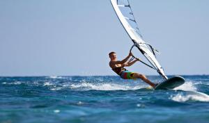 Un hombre está en una tabla de surf en el océano. en Villa AP, en Hikkaduwa