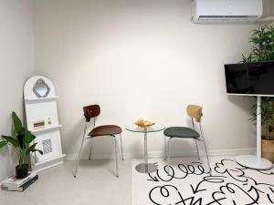 a living room with two chairs and a table at DMC Station,Airport Railroad,Hongdae 10 minutes,King size bed,Family, Group accommodation,JINJIN STAY,Air conditioning in each room in Seoul
