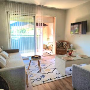 a living room with a couch and a table at STUDIO bord de mer in San-Nicolao
