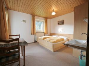 a bedroom with a bed and a sink at Chalet in Ellmau near Skiwelt Slopes in Ellmau +24 photos