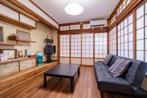 a living room with a couch and a table at サフラン in Kumejima