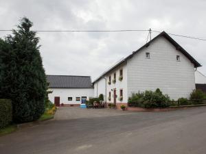 a white building with a black roof at Hontheim Farmhouse Retreat in Sellerich