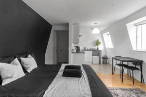 a bedroom with a large bed with a black headboard at Large Delux Studio - 26 in Leicester