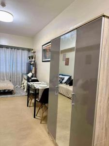 a room with a sliding door and a bedroom at Savannah Staycation in Davao City +7 photos
