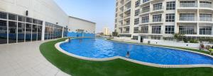 a large swimming pool in the middle of a building at Bahrain Amwaj in Amwaj Island