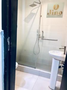 a bathroom with a shower and a sink at Emily Apartment in Lagos