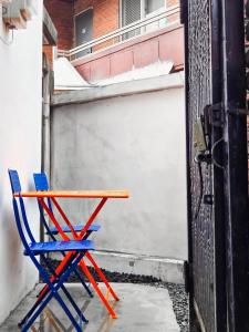 a blue and red chair sitting next to a building at Air conditioner 4 people Line 2 Sillim Station Parking Outdoor table Seoul tour Gocheok Dome K-pop lovers' hideout in Seoul