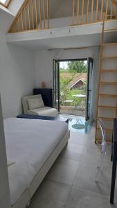 a bedroom with two bunk beds and a balcony at Modern Retreat in Kent Countryside in Tonbridge