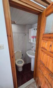 a bathroom with a toilet and a sink at Comfort and unparalleled view in Kóronos +22 photos