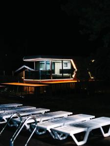 a boat in the water at night with some tables at АТЫРАУ Авенью in Zhezdi