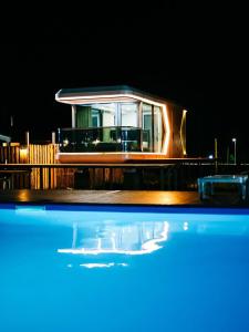 a house at night with a pool in the foreground at АТЫРАУ Авенью in Zhezdi