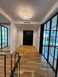 a hallway with a staircase and a chandelier at Luxury Villa Silente in Mjull-Bethore
