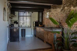 a kitchen with a counter and a sink in a room at Rust en romantiek in Maasland in Maasland +34 photos