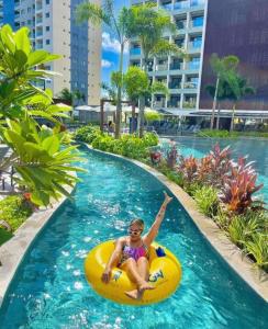 ein junges Mädchen, das auf einem Floß in einem Schwimmbad reitet in der Unterkunft Salinas Premium Resort in Salinópolis