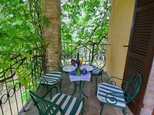 a table and chairs on a patio at Farmhouse in Todi with Pool & Theater Nearby in Chioano