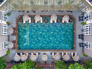 an overhead view of a swimming pool in a building at Hotel Royal Hoi An Danang, The Legacy Riverfront Resort & Spa in Hoi An