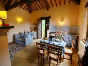 a living room with a table and chairs and a couch at Farmhouse in Todi with Pool & Theater Nearby in Chioano