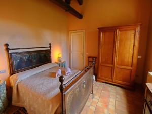 a bedroom with a large bed with a wooden frame at Farmhouse in Todi with Pool & Theater Nearby in Chioano